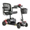 The Go Go™ Elite Traveller® 2 4-Wheel Scooter features a striking red and black design with four wheels, a front basket, a steering handle, and a comfortable padded seat with armrests.