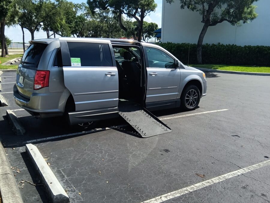 Silver Dodge Grand Caravan with Adaptive Vans Side Entry Automatic Fold Out conversion